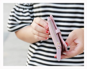 Detail of pink lychee leather wallet with durable metal zipper and long pull tab