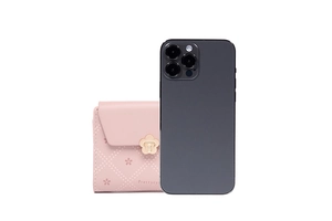 Short pink floral purse shown next to a smartphone for size comparison and scale