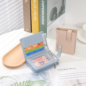 Close-up of minimalist bifold wallet with leaf metal clasp and multiple card slots