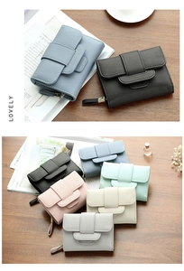 Detailed view of women's short wallet showing pebbled leather texture and multi-color options
