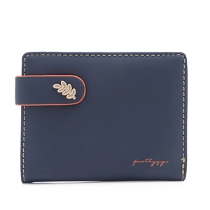 Detail of short navy wallet with orange strap and golden leaf charm pendant