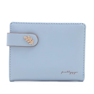 Detail of light blue short wallet featuring a golden leaf clasp and snap closure