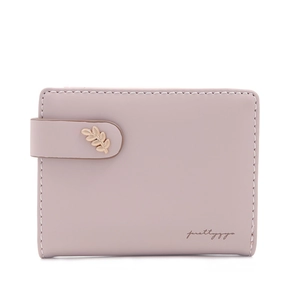 Detail of a minimalist pink leather short wallet with a golden leaf buckle and fine stitching