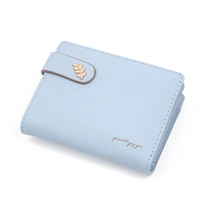 Detail view of light blue wallet with gold leaf hardware and smooth stitching texture