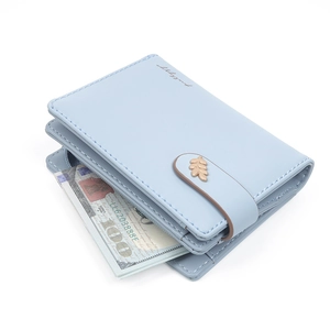 Detail of light blue faux leather wallet featuring gold leaf clasp and bill compartment