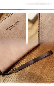 Detail view of pink leather long wallet with Forever Young embossing and gold zipper
