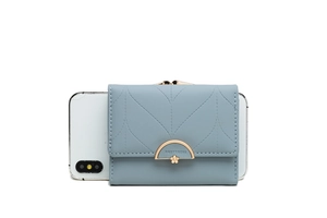 Close-up of light blue trifold wallet featuring leaf quilting and golden floral clasp