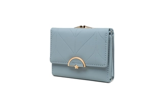 Detailed view of light blue tri-fold wallet with leaf stitching and gold flower clasp