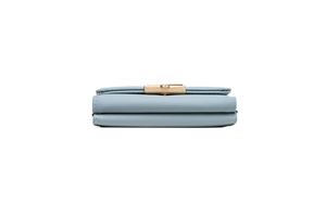 Side view of light blue tri-fold wallet showing thick layered structure and gold buckle