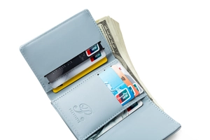 Internal detail of light blue leather tri-fold wallet with card slots and cash pocket
