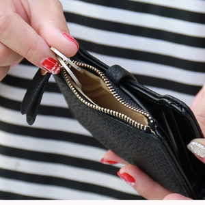 Black pebbled leather short wallet for women featuring gold zipper and coin compartment