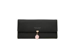 Detail of long black wallet with gold fastener and pink leaf pendant decoration