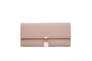 Detail of dusty pink leather wallet with golden buckle, leaf pendant and embossed logo