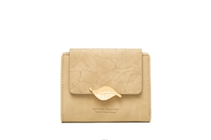 Detailed macro view of khaki leaf clasp buckle and botanical print on bifold wallet