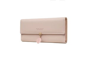 Detail of light pink long wallet featuring matte leather and a gold leaf charm pendant