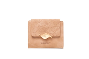 Close-up of pink short wallet featuring embossed leaf texture and gold metal buckle