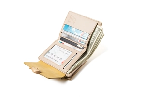 Interior detail of apricot tri-fold wallet showing multiple card slots and cash pocket