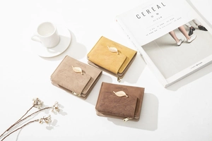 Three multi-functional zip wallets in autumn tones styled with minimalist home decor