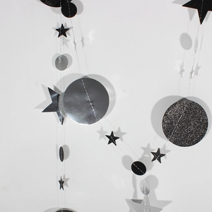Detail of hanging star and circle garland with black glitter and mirror silver finish