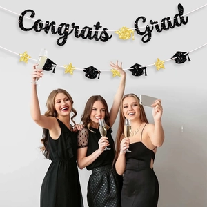 Glittery gold Congrats Grad banner with black mortarboard and star decorations for 2026