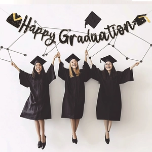 Glittery Happy Graduation banner held by students in gowns for party wall decoration