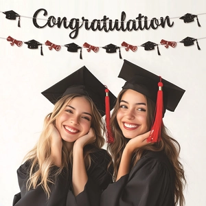 Graduation party decoration set featuring black glitter banner and academic cap garlands