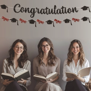 Glittery Congratulation banner with black graduation caps and red scrolls party decor