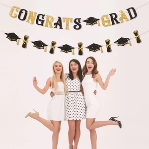 Glittering black and gold CONGRATS GRAD banner set for graduation party scene decoration