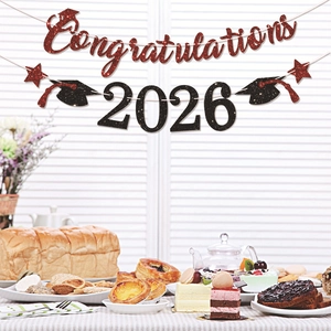 Glittery 2026 graduation party banner set with red and black lettering for celebration