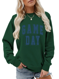 Close-up of GAME DAY lettering on deep green crewneck sweatshirt with knit texture