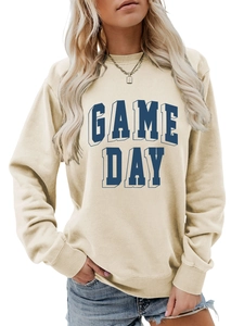Detail of ribbed collar and blue GAME DAY block lettering on cream sweatshirt
