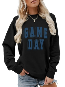 Close-up of GAME DAY block lettering on black crewneck sweatshirt with cotton texture