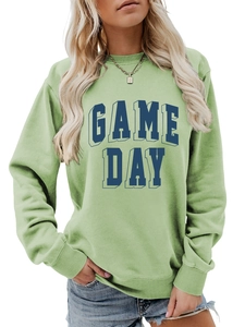 Detail showing GAME DAY raised lettering on a light green crewneck sweatshirt