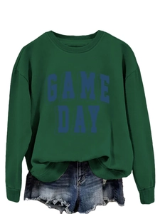 Close-up of ribbed cuffs and 3D Game Day lettering on a dark green cotton sweatshirt