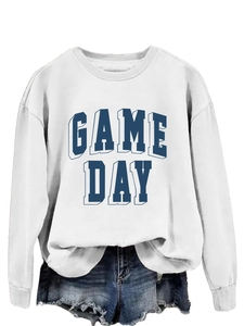 Close-up of a white Game Day sweatshirt with navy blue shadow lettering and denim shorts