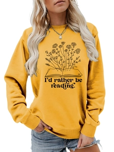 Close-up of 'I'd rather be reading' book and flower print on yellow long sleeve sweatshirt