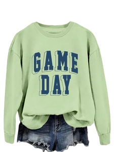 Detailed view of light green crewneck sweatshirt featuring navy GAME DAY 3D typography
