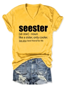 Detail of yellow V-neck T-shirt with text and frayed denim shorts set on white background