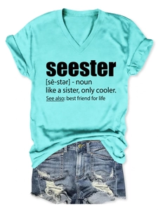 Flat lay detail of mint green V-neck T-shirt with seester text and denim shorts