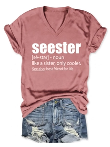 Flat lay of a dusty rose V-neck t-shirt with seester print and distressed denim shorts