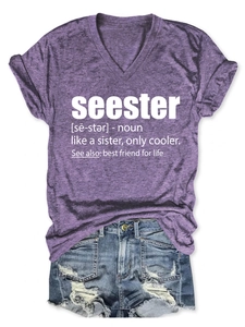 Close-up of seester text print on a purple V-neck T-shirt paired with denim shorts