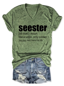 Detail of olive green V-neck T-shirt with 'seester' print and distressed denim shorts