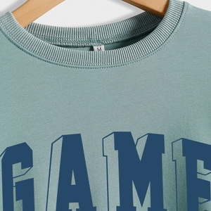 Sage green round neck sweatshirt with 3D blue GAME print and ribbed neckline detail