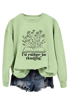 Detail of light green sweatshirt featuring book floral print and I'd rather be reading text