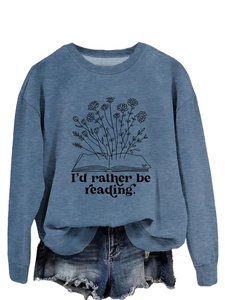 Detail of the 'I'd rather be reading' floral graphic print on a denim blue sweatshirt