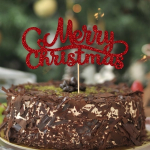 Sparkling red glitter Merry Christmas cake topper on a festive chocolate dessert with bokeh background