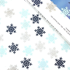 Flat lay of blue and glittery silver snowflake confetti for Christmas party decoration