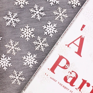 100pcs white snowflake confetti for Christmas decor on a minimalist background