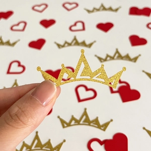 Sparkling gold crown and red heart confetti for wedding and romantic party decoration