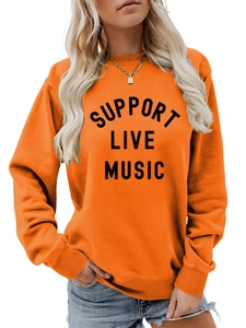Close-up of Support Live Music vintage black print on vibrant orange crewneck sweatshirt